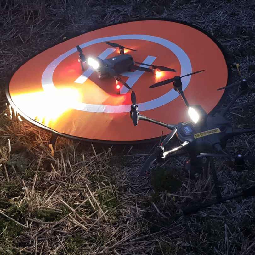 2 of my drones on landing pad at night 31 11zon