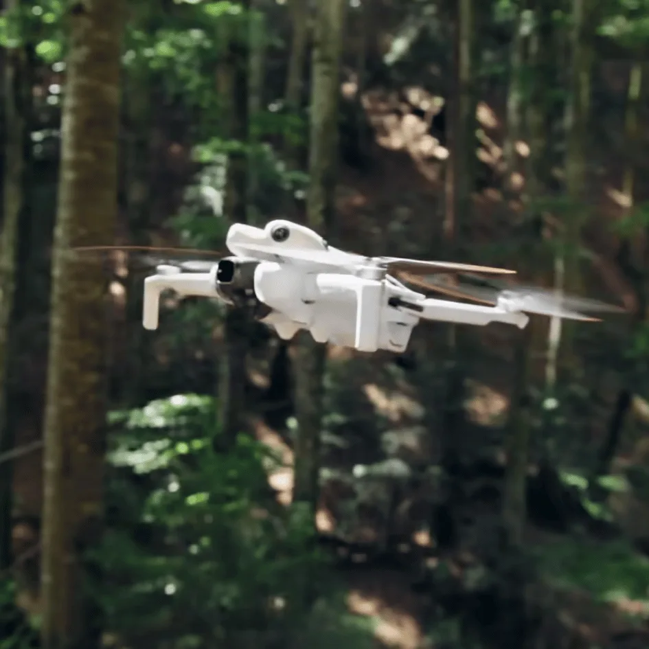 dji mini 4 pro flying in forest